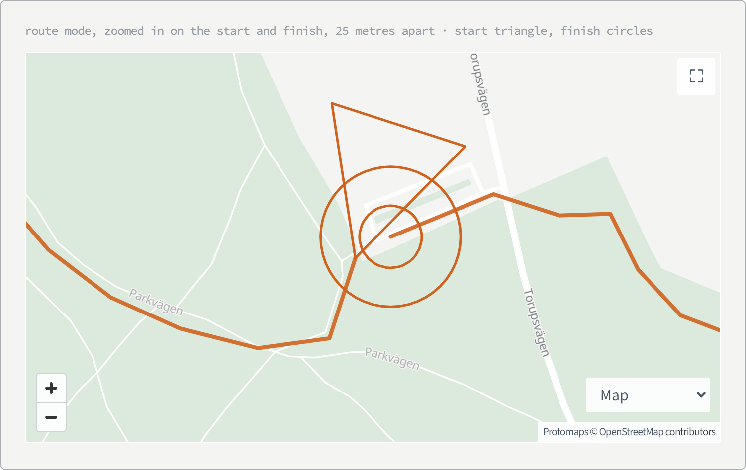 A pale green map of park paths with an orange route line running through it. Where the line begins, a hollow orange triangle with its apex on the track and its body trailing back; a few metres away, two hollow concentric orange circles marking the finish.